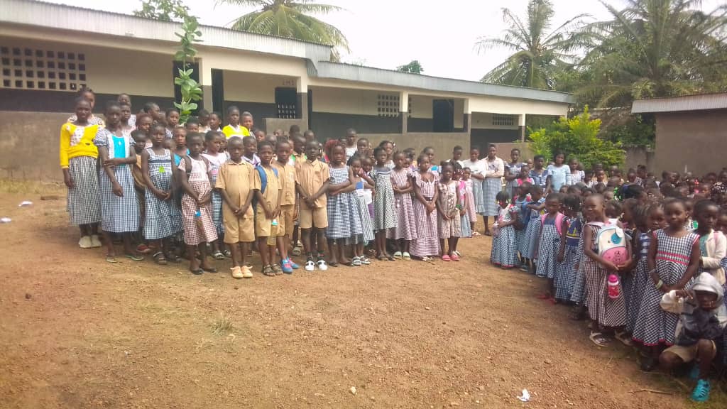 Students of Groupe Scolaire Agbé gathered outside their school in Lakota, Côte d'Ivoire